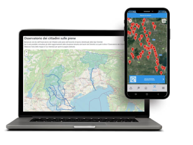 Un'immagine che mostra un laptop computer e un cellulare. Sul display del laptop è aperta una mappa che rappresenta un'area geografica con diverse zone colorate in diverse tonalità di blu. Il cellulare è chiuso e non è visibile il display. L'immagine è in linea con le linee guida di accessibilità dell'AgID.